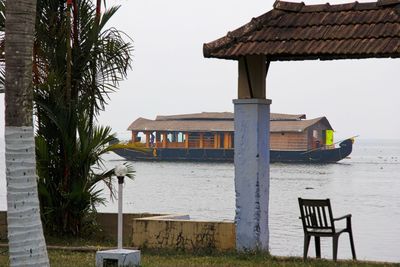 Scenic view of houseboat sailing in calm water against clear sky