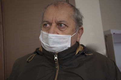 Close-up of man wearing mask looking away