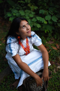 Portrait of contemplative and dreamy young arhuaco indigenous woman in a forest of colombia