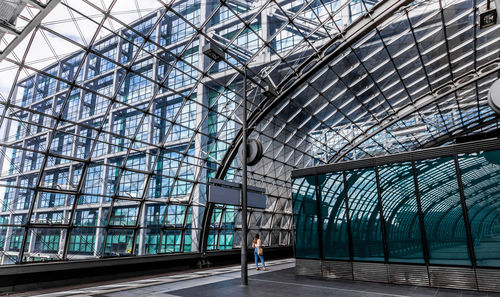 Low angle view of woman walking in modern building