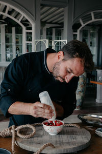 Man preparing food at table