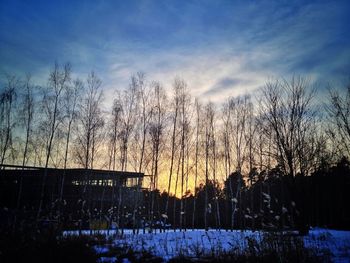 Scenic view of snow covered landscape at sunset