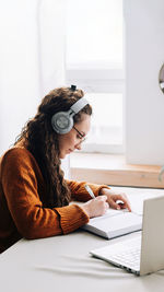 Young woman using laptop at home