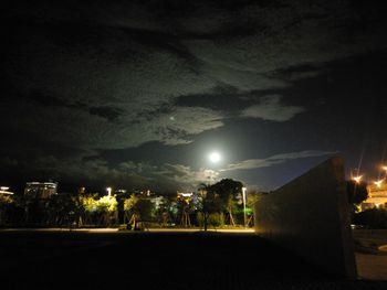 Illuminated city against sky at night