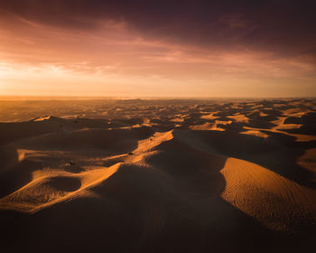 Dramatic sky looming of the endless dunes of the desert