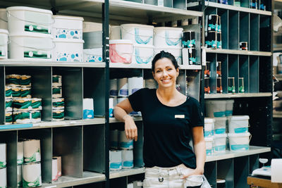 Portrait of smiling sales woman standing in hardware store