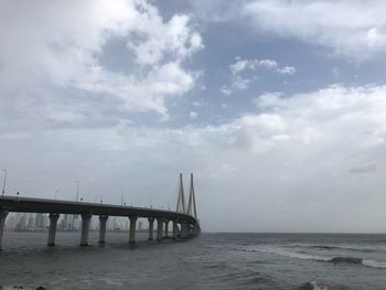 Bridge over sea against sky