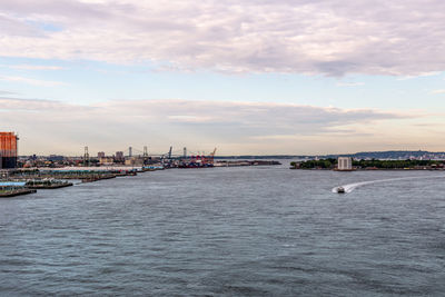 Scenic view of sea by city against sky