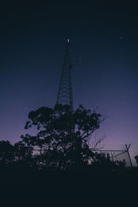 Low angle view of silhouette trees against sky at night