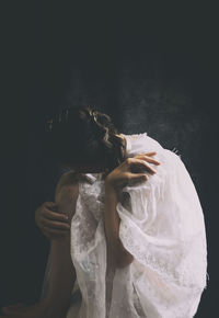 Woman with old white embroidered cloak ii