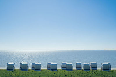 Wicker beach chair in a row at the sea