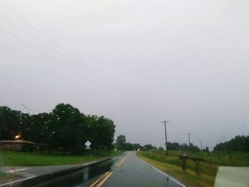 Wet road against sky