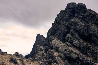 Low angle view of rock formation against sky