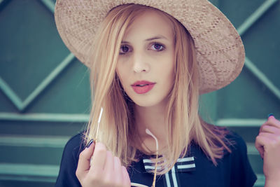 Portrait of beautiful young woman in hat