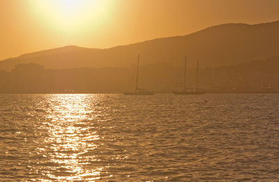 Scenic view of sea against orange sky