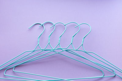 Hangers for clothes on purple background