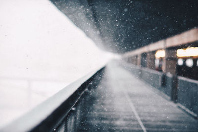 Empty corridor during snowfall