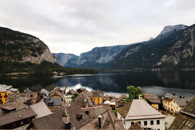 High angle view of town by lake against sky