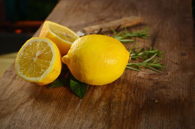Close-up of lemons with herbs on cutting board