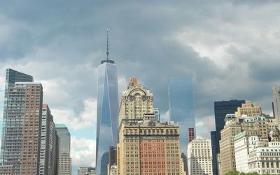 Low angle view of buildings against cloudy sky