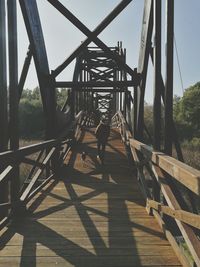 Rear view of people walking on footbridge