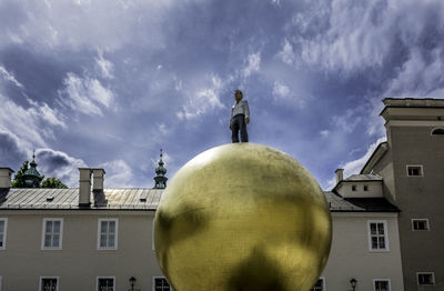 Low angle view of statue against cloudy sky