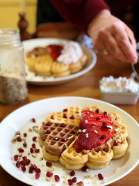 High angle view of waffles with strawberry in plate on table
