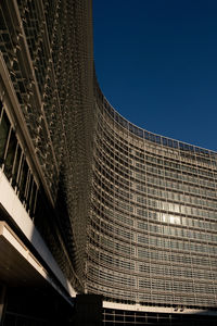 Low angle view of modern building against clear blue sky