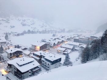 Aerial view of snow covered landscape and buildings