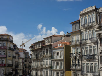 Low angle view of buildings in town against sky