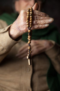 Close-up of hand holding cross