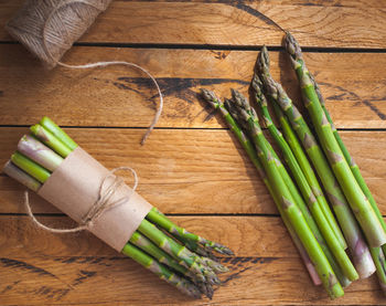 Fresh green asparagus on wooden background, top view