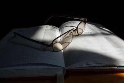 Close-up of eyeglasses on open book 