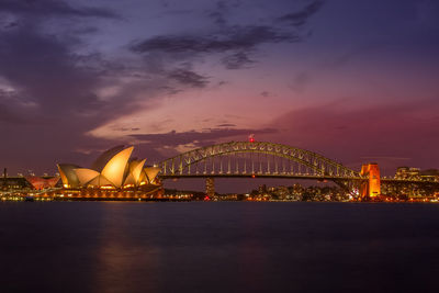 Illuminated city against sky at night