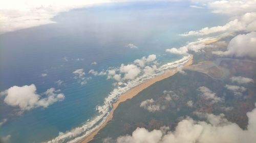 Aerial view of aircraft wing against sky