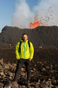 Portrait of man standing against mountain