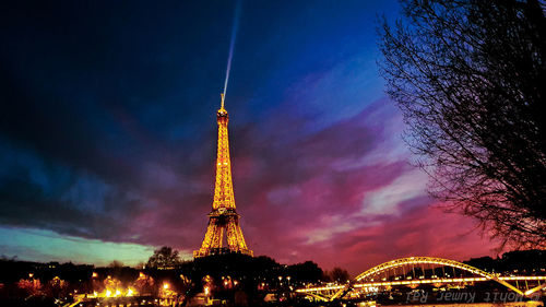 Low angle view of illuminated tower at night