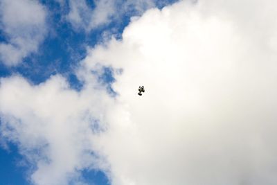 Low angle view of airplane flying in sky