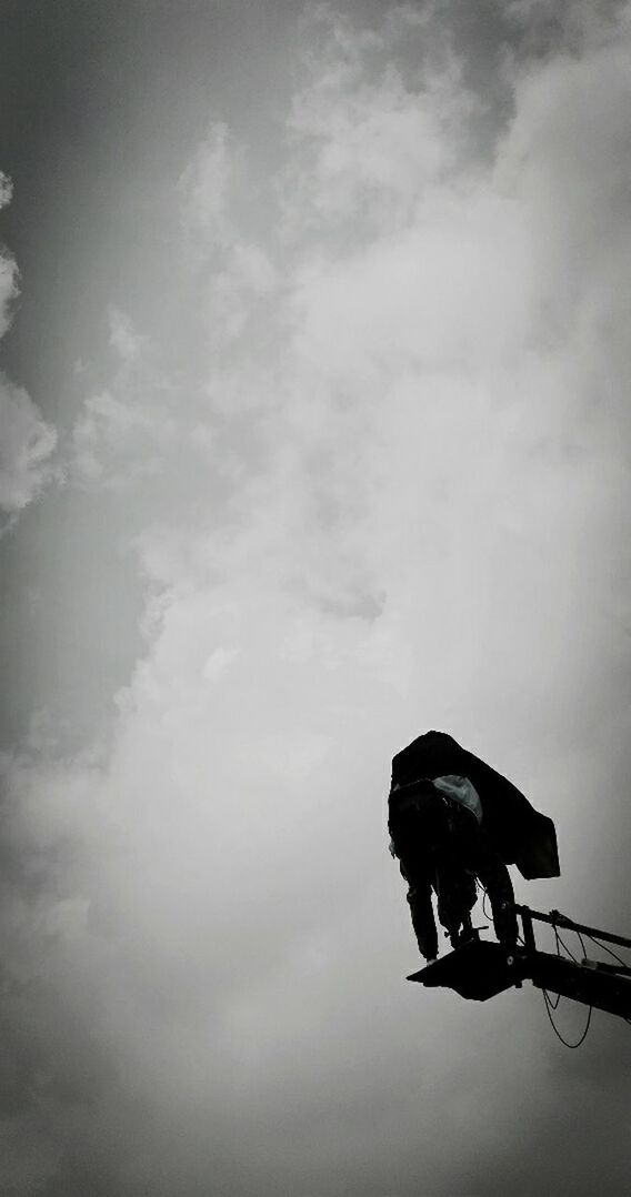 sky, low angle view, silhouette, cloud - sky, outdoors, metal, day, nature, dusk, no people, rope, hanging, animal representation, cloud, cloudy, connection, full length, perching, close-up, danger