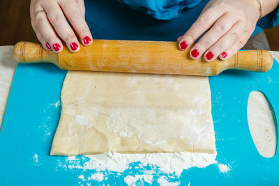 Women's hands roll out the dough. gomentash biscuits with poppy seeds, traditional for the jewish