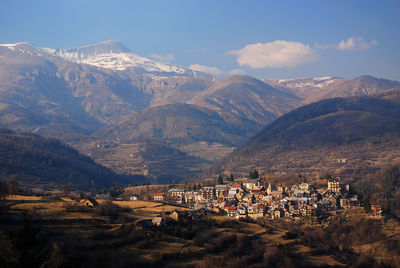 High angle view of townscape and mountains against sky