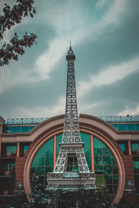 Tower against cloudy sky