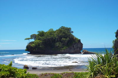 Scenic view of sea against clear blue sky