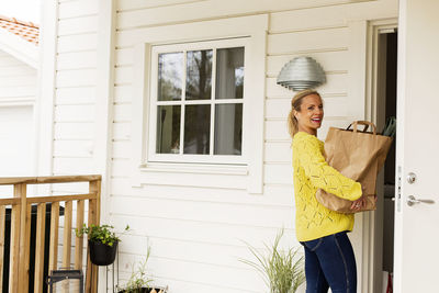 Woman holding paper bag with shopping