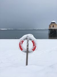 Heart shape with ice cream against sky during winter