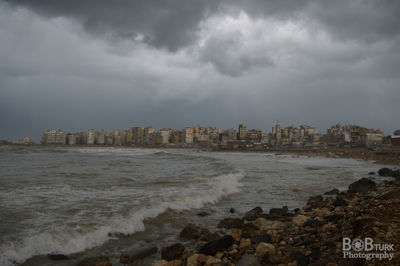 Scenic view of sea and buildings against sky