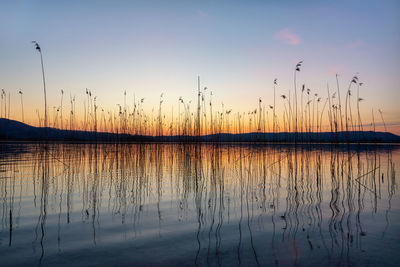 Scenic view of lake against sky during sunset