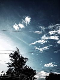Low angle view of silhouette birds flying against sky