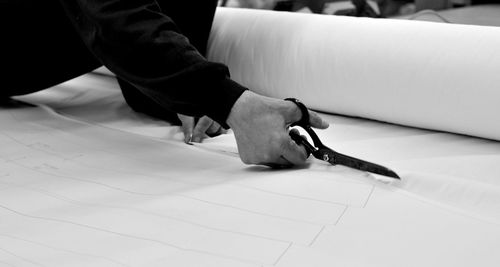 High angle view of woman holding paper on table