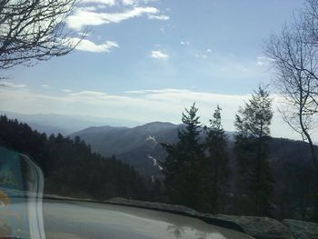 Scenic view of mountains against cloudy sky